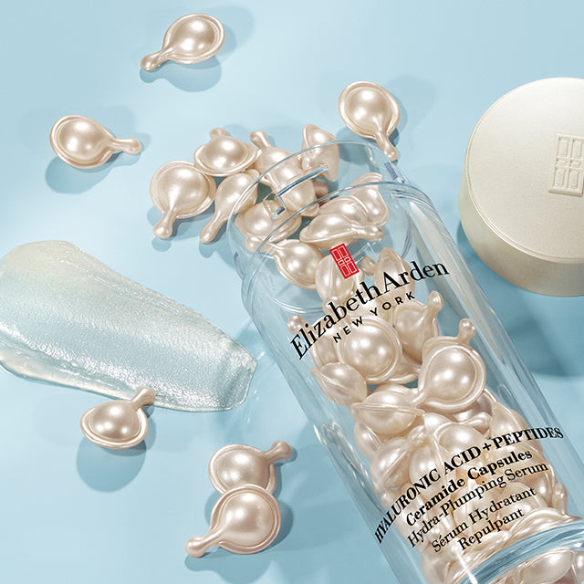 Hyaluronic Acid + Peptides Ceramide Capsules spilled on blue background