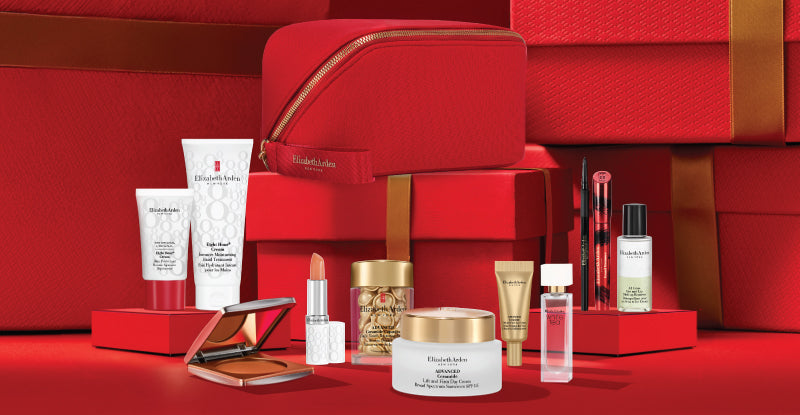 Collection of Elizabeth Arden skincare and makeup products with beauty bag on a red background - mobile